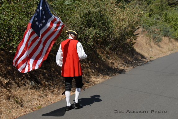 Patriot with flag in American Revolution costume