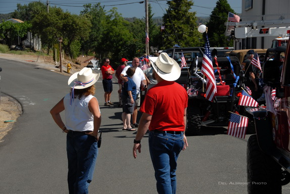 Cowboy hats discussing parade with flags